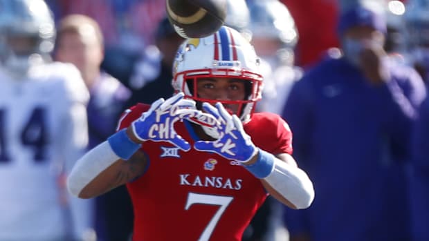 Kansas redshirt sophomore Trevor Wilson (7) eyes a throw from redshirt junior Jason Bean in the first quarter of Saturday's Sunflower Showdown against Kansas State at David Booth Kansas Memorial Field.